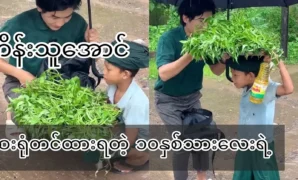 A ten-year-old boy selling sweet potato leaves in the rainy village 